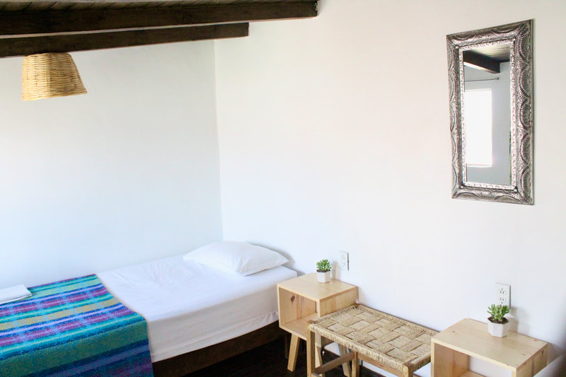 CABANJAH CUARTO:

Private room with two single beds, shares bathroom and showers. Recommended if you are traveling with a friend and want individual beds and privacy. Not recommended if privacy is not your priority. Can fit up to 2 people.