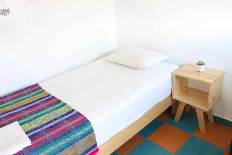 CUARTO LUCHA'S:

Private room with a queen size bed, bathrooms and showers outside the room. Recommended if you are solo travelers who needs a break from "dorm life". Not recommended if privacy is not your priority. Can fit up to 2 persons.